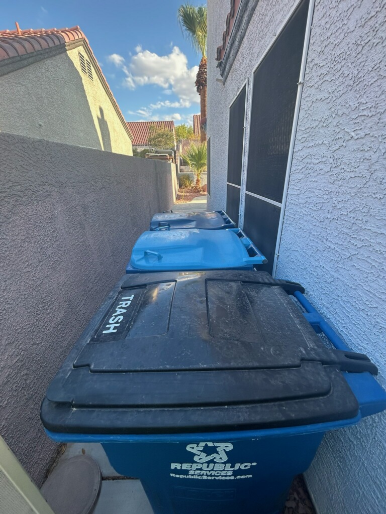Residential trash and recycling bins returned beside a Las Vegas home